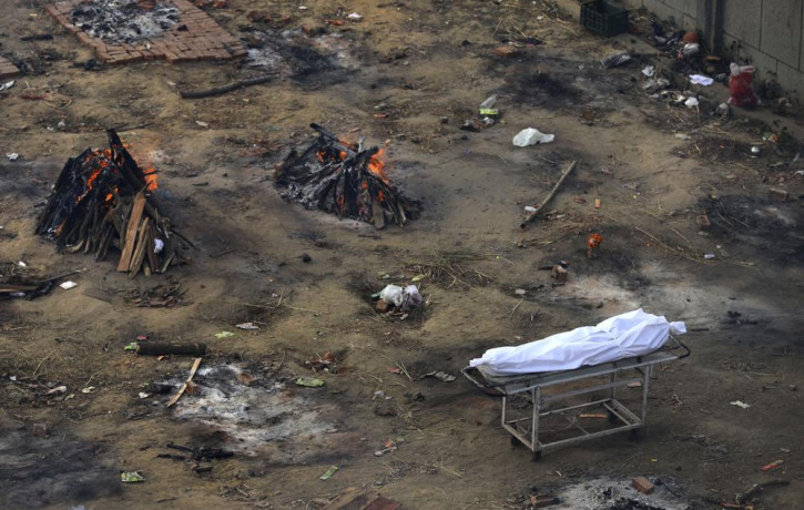Multiple funeral pyres of those patients who died of COVID-19 disease are seen burning at a ground that has been converted into a crematorium for mass cremation of coronavirus victims, in New