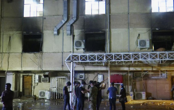 In this image made from video, first responders work the scene of a fire at a hospital in Baghdad on Saturday, April 24, 2021.