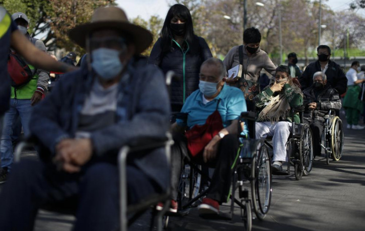 In this Feb. 24, 2021, file photo, elderly residents of the Iztacalco borough wait in line to receive doses of the Russian COVID-19 vaccine Sputnik V in Mexico City.
