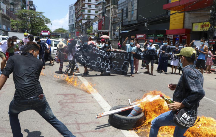 Anti-coup protesters burn tires and chant slogans with banner read ''The Kamayut strike will be fight for to the end when we get victory" during the demonstration against the military coup in