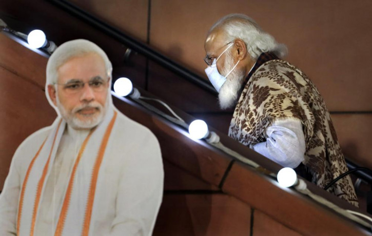 In this Nov. 11 2020, file photo, Indian Prime Minister Narendra Modi leaves after a function at the Bharatiya Janata Party headquarters following a state election in New Delhi, India.
