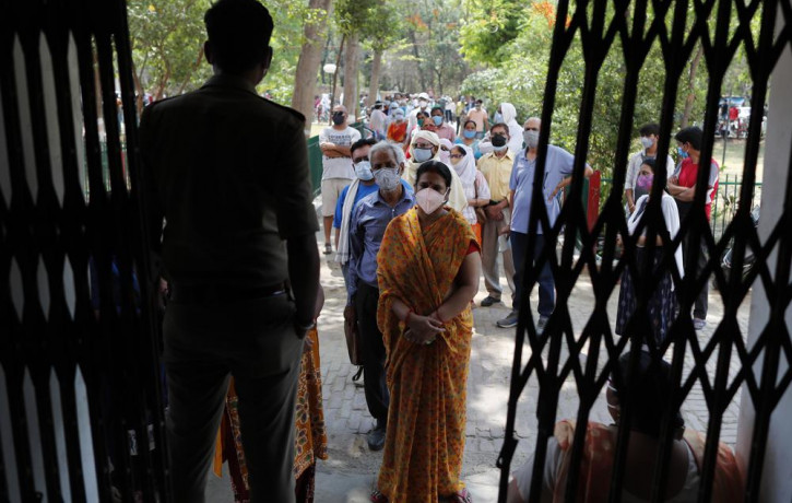 Indians line up to receive the vaccine for COVID-19 at a medical college in Prayagraj, India, Saturday, May 8, 2021.