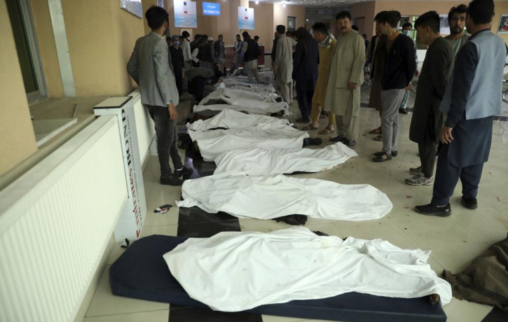 Afghan men try to identify the dead bodies at a hospital after a bomb explosion near a school west of Kabul, Afghanistan, Saturday, May 8, 2021.