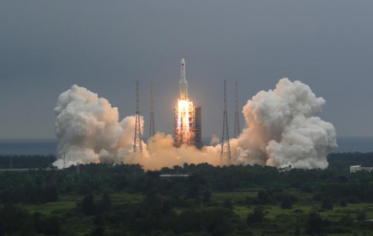 In this April 29, 2021, file photo released by China's Xinhua News Agency, a Long March 5B rocket carrying a module for a Chinese space station lifts off from the Wenchang Spacecraft Launch S