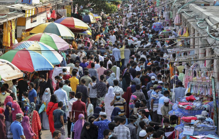 Shoppers crowd at a marketplace in Dhaka, Bangladesh, Friday, May 7, 2021. India's surge in coronavirus cases is having a dangerous effect on neighboring Bangladesh.