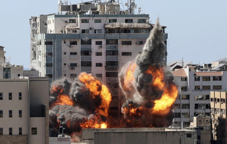 A ball of fire erupts from a building housing various international media, including The Associated Press, after an Israeli airstrike on Saturday, May 15, 2021 in Gaza City.