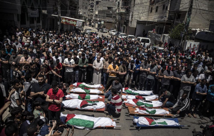 Palestinians attend the funeral of two women and eight children of the Abu Hatab family in Gaza City, who were killed after an Israeli air strike, Saturday, May 15, 2021.