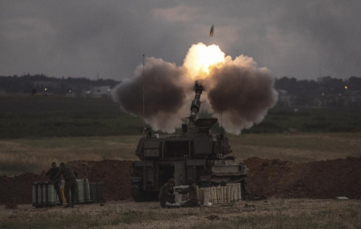 An Israeli artillery unit fires toward targets in the Gaza Strip, at the Israeli Gaza border, Monday, May 17, 2021.