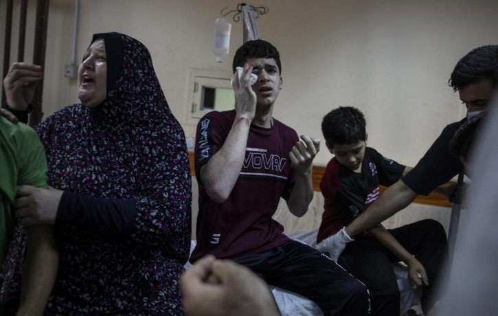 In this May 17, 2021, file photo, Palestinians receive treatment at the Shifa Hospital for their wounds caused by an Israeli airstrike in Gaza City.