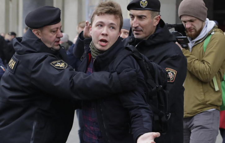 In this Sunday, March 26, 2017 file photo, Belarus police detain journalist Raman Pratasevich, center, in Minsk, Belarus.