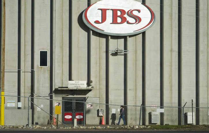 In this Oct. 12, 2020 file photo, a worker heads into the JBS meatpacking plant in Greeley, Colorado.