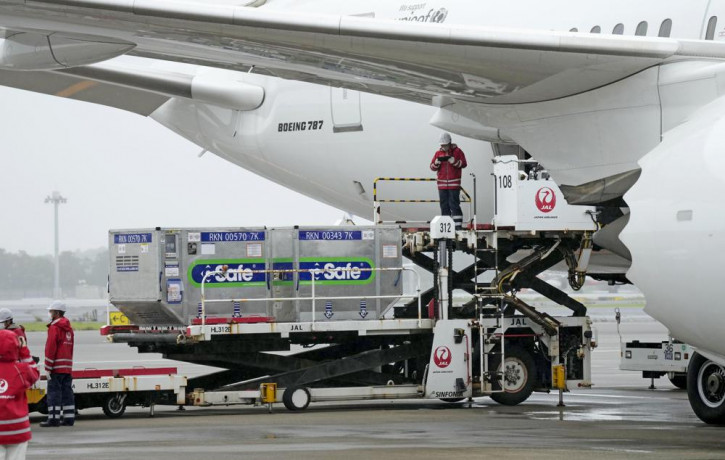 The containers carrying the coronavirus vaccines donated by Japanese government, are loaded to a plane before its departure for Taiwan, at Narita International Airport in Narita, east of Toky