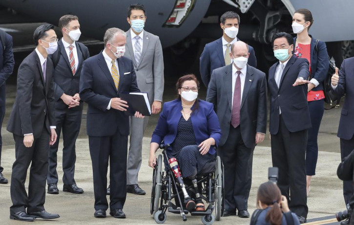 Taiwan's Foreign Minister Joseph Wu, second right, gestures as he welcomes U.S. senators on their arrival at the Songshan Airport in Taipei, Taiwan on Sunday.