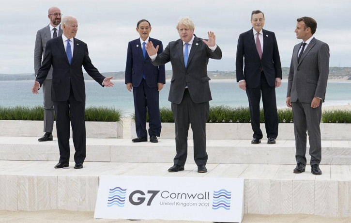 US President Joe Biden and British Prime Minister Boris Johnson gesture as they pose for a family photo with G-7 leaders in Carbis Bay, England, Friday, June 11, 2021.