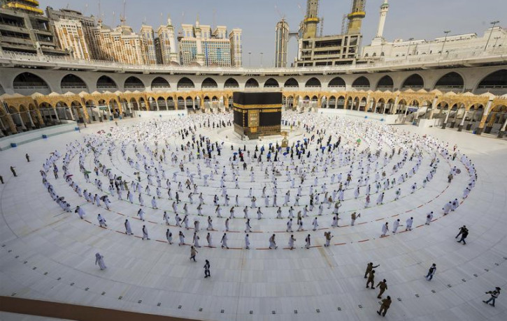 In this July 31, 2020, file photo, pilgrims walk around the Kabba at the Grand Mosque in the Muslim holy city of Mecca, Saudi Arabia.