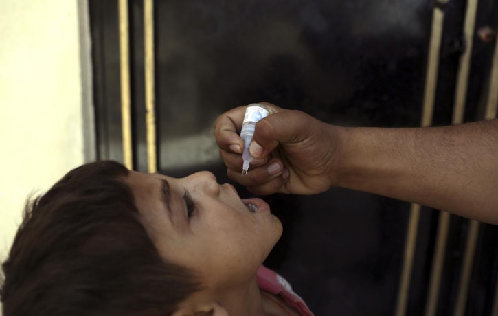 A health worker administers a vaccination to a child during a polio campaign in the old part of Kabul, Afghanistan, Tuesday, June 15, 2021.