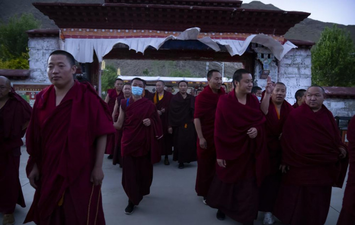 Monks prepare to go to dinner at the Tibetan Buddhist College near Lhasa in western China's Tibet Autonomous Region, Monday, May 31, 2021, as seen during a government organized visit for fore