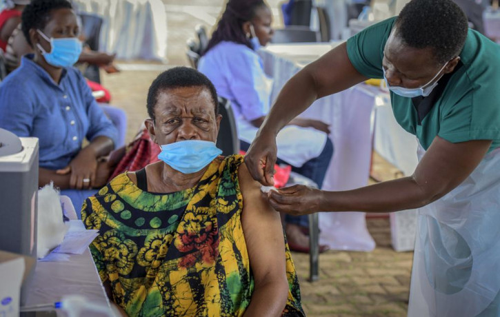 A woman receives a coronavirus vaccination at the Kololo airstrip in Kampala, Uganda, Monday, May 31, 2021.