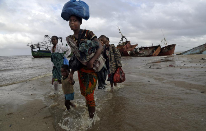 In this Saturday, March 23, 2019 file photo, displaced families arrive after being rescued by boat from a flooded area of Buzi district, 200 kilometers (120 miles) outside Beira, Mozambique.