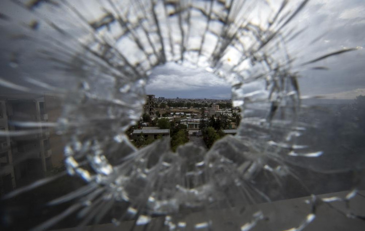 In this Thursday, May 6, 2021 file photo, the city of Mekele is seen through a bullet hole in a stairway window of the Ayder Referral Hospital, in the Tigray region of northern Ethiopia.