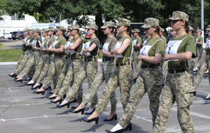 In this photo taken and released by the Ukrainian Defense ministry press-service on July 2, 2021, Ukrainian female soldiers wear heels while taking part in the the military parade rehearsal i