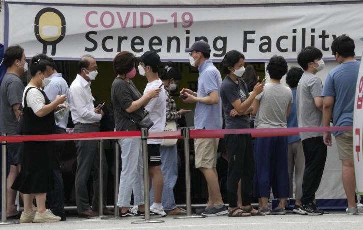 People queue in line to wait for the coronavirus testing at a Public Health Center in Seoul, South Korea, Friday, July 9, 2021.