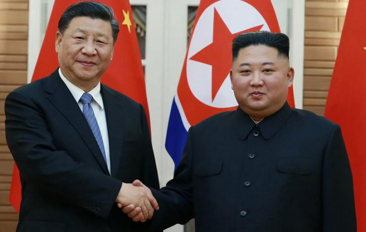 In this June 20, 2019, file photo provided by the North Korean government, North Korean leader Kim Jong Un, right, poses with Chinese President Xi Jinping for a photo at Kumsusan guest house 