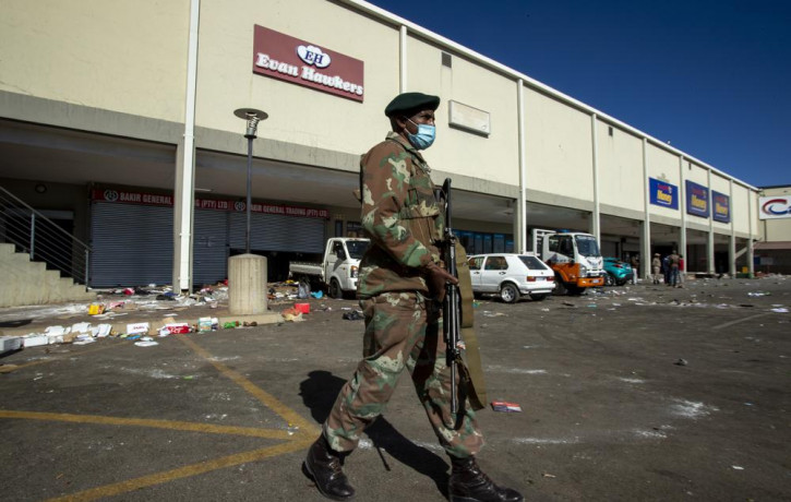 A soldiers patrol at a shopping centre in Soweto, Johannesburg Tuesday July 13, 2021.