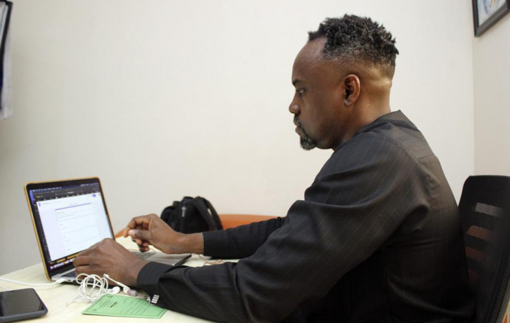 Dr. Ifeanyi Nsofor works on his laptop inside his office in Abuja, Nigeria, Monday, July 12, 2020.
