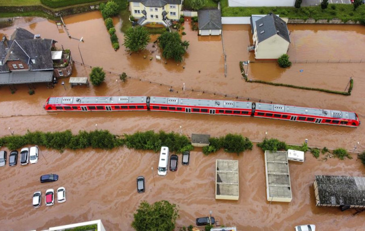 A regional train sits in the flood waters at the local station in Kordel, Germany, Thursday July 15, 2021 after it was flooded by the high waters of the Kyll river.