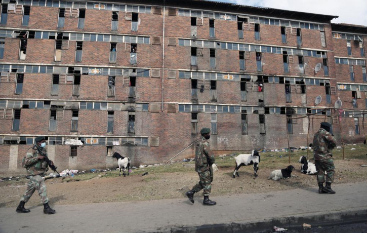 South African Defence Force soldiers on patrol alongside the male single sex hostels in Alexandra Township, north of Johannesburg, Thursday, July 15 2021.
