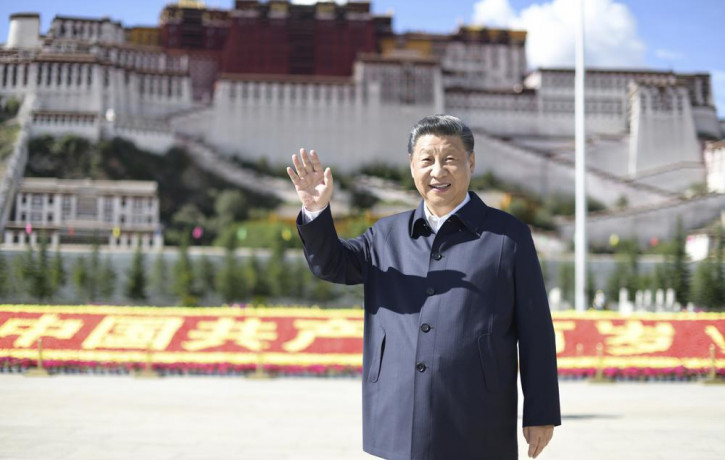 In this July 22, 2021 photo released by China's Xinhua News Agency, Chinese President Xi Jinping waves while visiting a public square below the Potala Palace in Lhasa in western China's Tibet