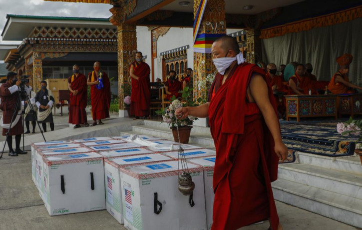 This photograph provided by UNICEF shows monks from Paro's monastic body perform a ritual as 500,000 doses of Moderna COVID-19 vaccine gifted from the United States arrived at Paro Internatio