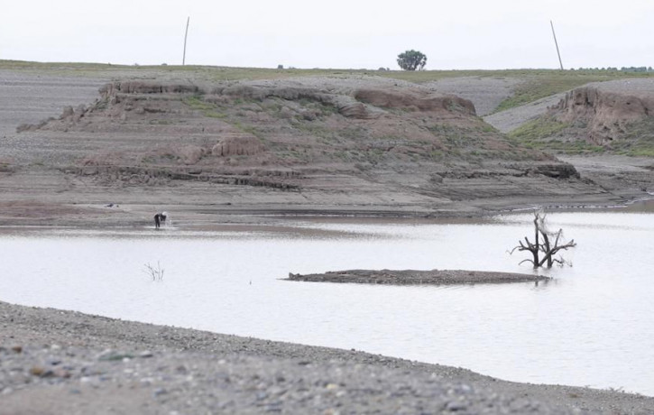 In this photo taken from a video shot on Wednesday, Aug. 4, 2021 in Wad el-Hilu, Sudan, a man washes in the Setit river, known in Ethiopia as Tekeze River.