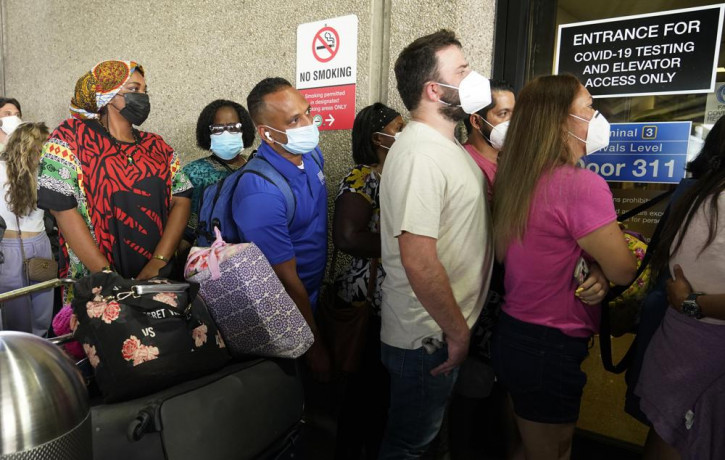 Passengers wait in a long line to get a COVID-19 test to travel overseas at Fort Lauderdale-Hollywood International Airport, Friday, Aug. 6, 2021, in Fort Lauderdale, Florida.