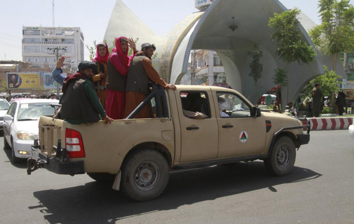 Taliban fighters pose on the back of a vehicle in the city of Herat, west of Kabul, Afghanistan, Saturday, Aug. 14, 2021, after they took this province from Afghan government.
