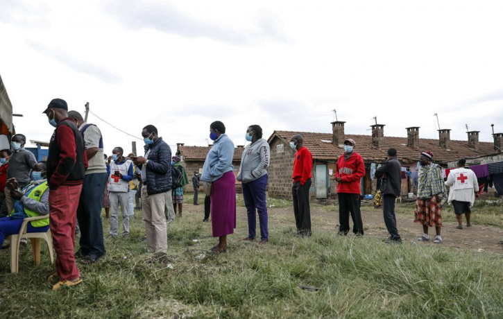 Kenyans queue to receive the AstraZeneca coronavirus vaccine donated by Britain, at the Makongeni Estate in Nairobi, Kenya Saturday, Aug. 14, 2021.