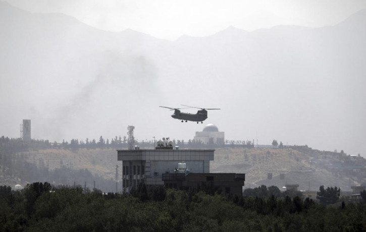 A US Chinook helicopter flies over the U.S. Embassy in Kabul, Afghanistan, Sunday, Aug. 15, 2021.