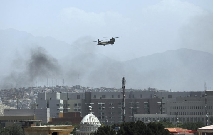 A U.S. Chinook helicopter flies over the city of Kabul, Afghanistan, Sunday, Aug. 15, 2021.
