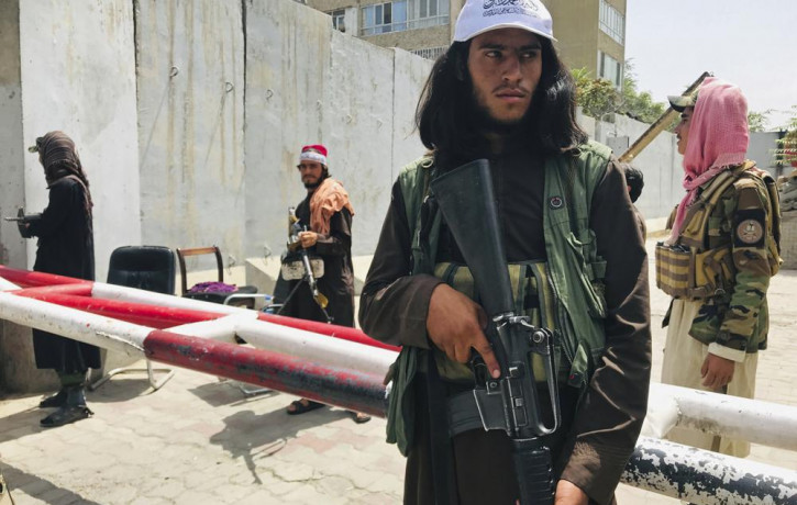 Taliban fighters stand guard at a checkpoint that was previously manned by American troops near the US embassy, in Kabul, Afghanistan, Tuesday, Aug. 17, 2021.