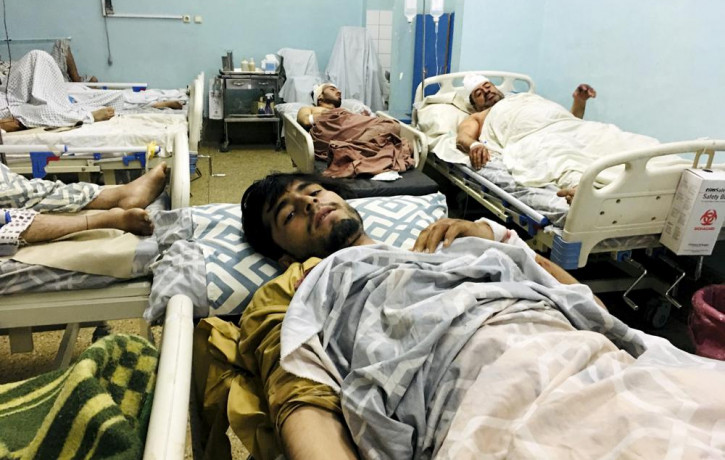 Wounded Afghans lie on a bed at a hospital after a deadly explosions outside the airport in Kabul, Afghanistan, Thursday, Aug. 26, 2021.