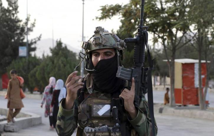 Taliban fighter stand guard at a checkpoint near the gate of Hamid Karzai international Airport in Kabul, Afghanistan, Saturday, Aug. 28, 2021.