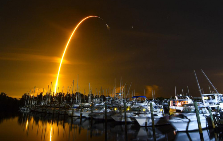 This long exposure photo shows the launch of a SpaceX Falcon 9 rocket on a resupply mission for NASA to the International Space Station from Pad 39A at Kennedy Space Center, seen from Merritt