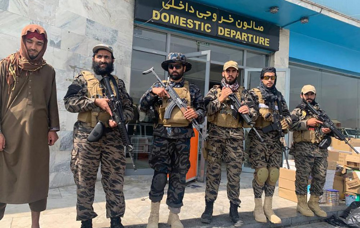 Taliban fighters stand guard inside the Hamid Karzai International Airport after the U.S. withdrawal in Kabul, Afghanistan, Tuesday, Aug. 31, 2021.