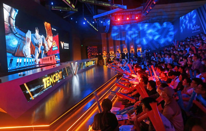 Fans watch the match of the 2020 League of Legends World Championship televised on a screen at a Tencent V-station in Shanghai, China, Oct. 31, 2020.