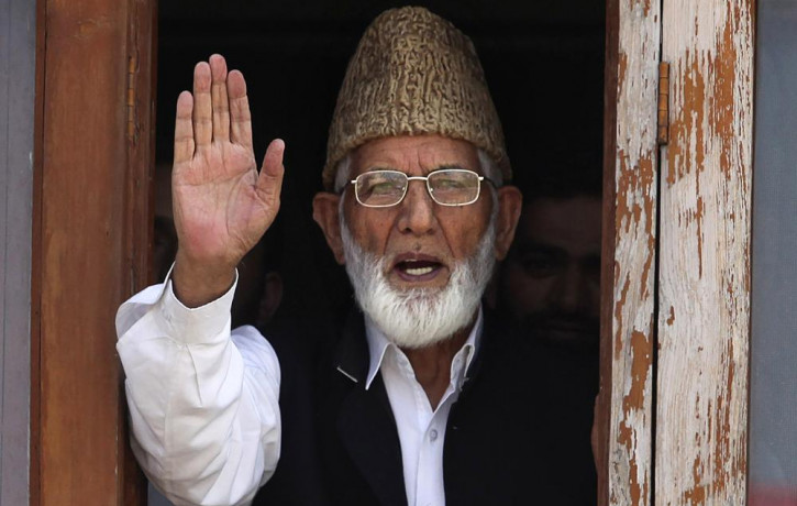 In this Wednesday, Sept. 8, 2010, file photo, Kashmiri separatist leader Syed Ali Shah Geelani waves to the media before his arrest in Srinagar, India.