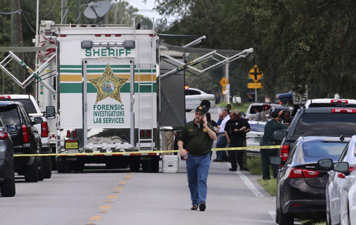 Polk County, Florida, Sheriff's officials work the scene of a multiple fatality shooting Sunday, Sept. 5, 2021, in Lakeland, Floridaa.