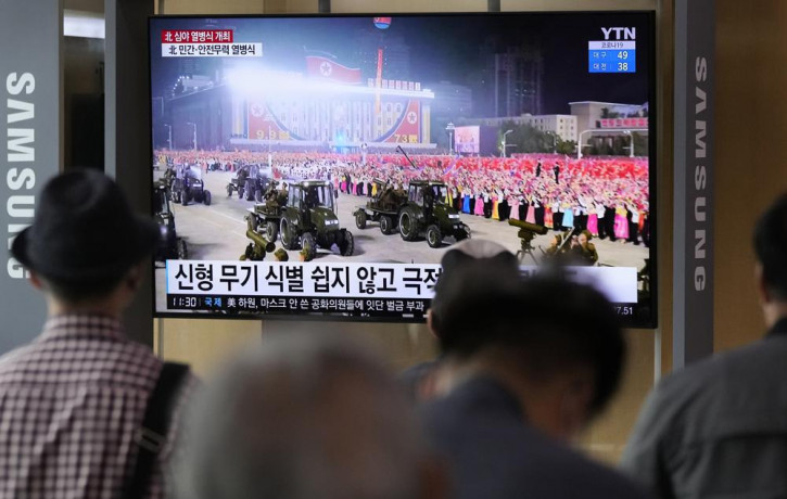People watch a TV showing a military parade held in Pyongyang, North Korea, at Seoul Railway Station in Seoul, South Korea, Thursday, Sept. 9, 2021.