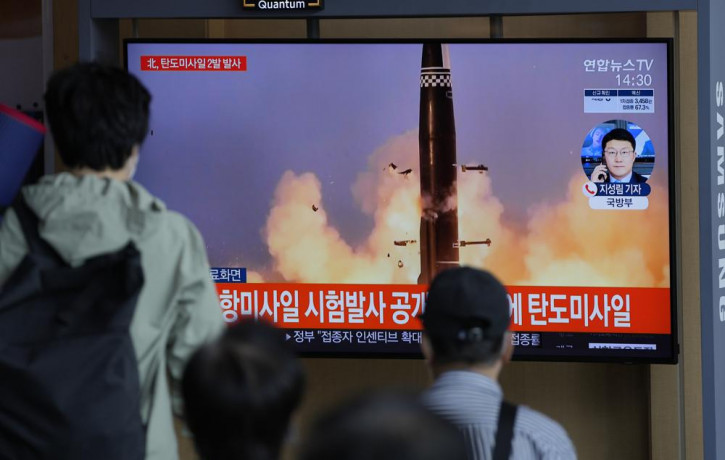 People watch a TV screen showing a news program reporting about North Korea's missiles with file image in Seoul, South Korea, Wednesday, Sept. 15, 2021.