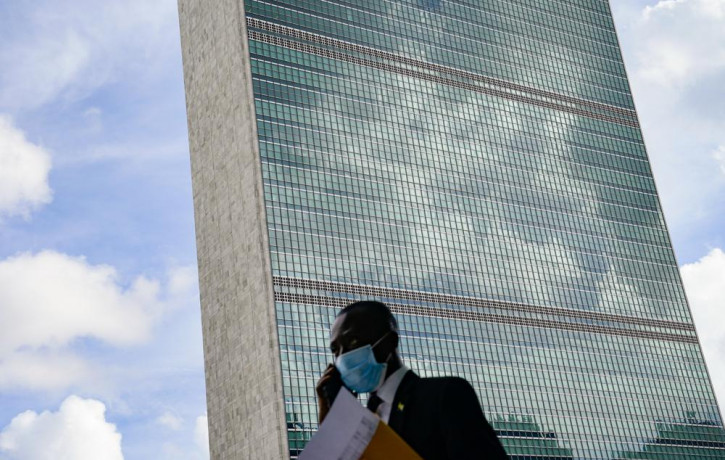 A pedestrian passes outside the United Nations headquarters, Tuesday, Sept. 21, 2021, during the 76th Session of the U.N. General Assembly in New York.